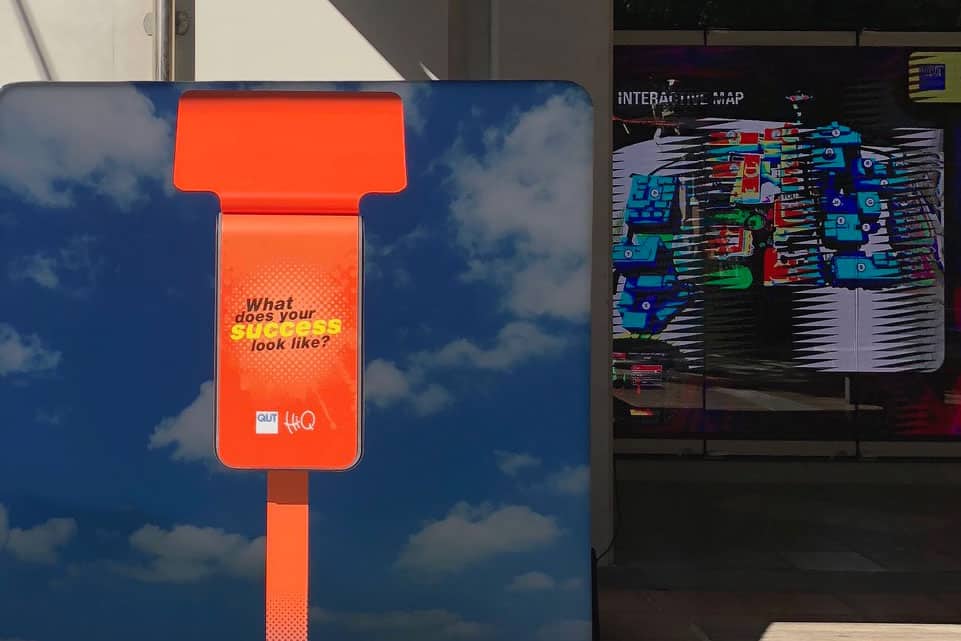 Orange photo booth in front of sky backdrop